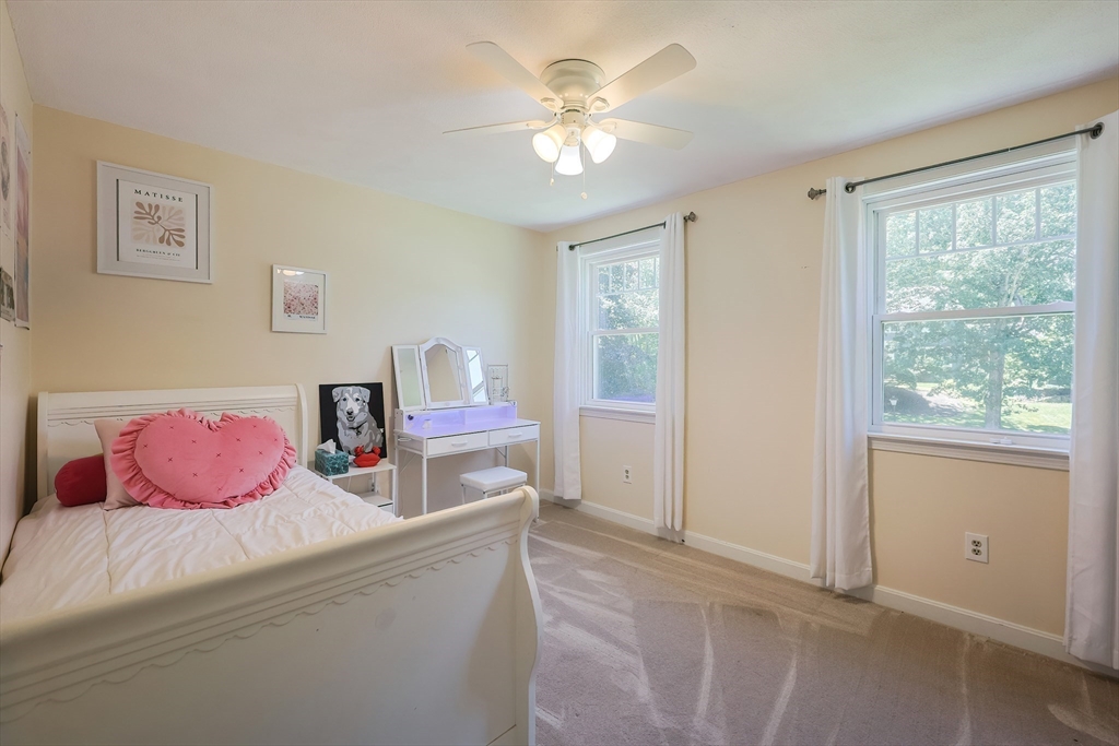 5 Windsor Road Lynnfield, MA 01940 - Photo 19 of 40 a bedroom with a bed and a chandelier