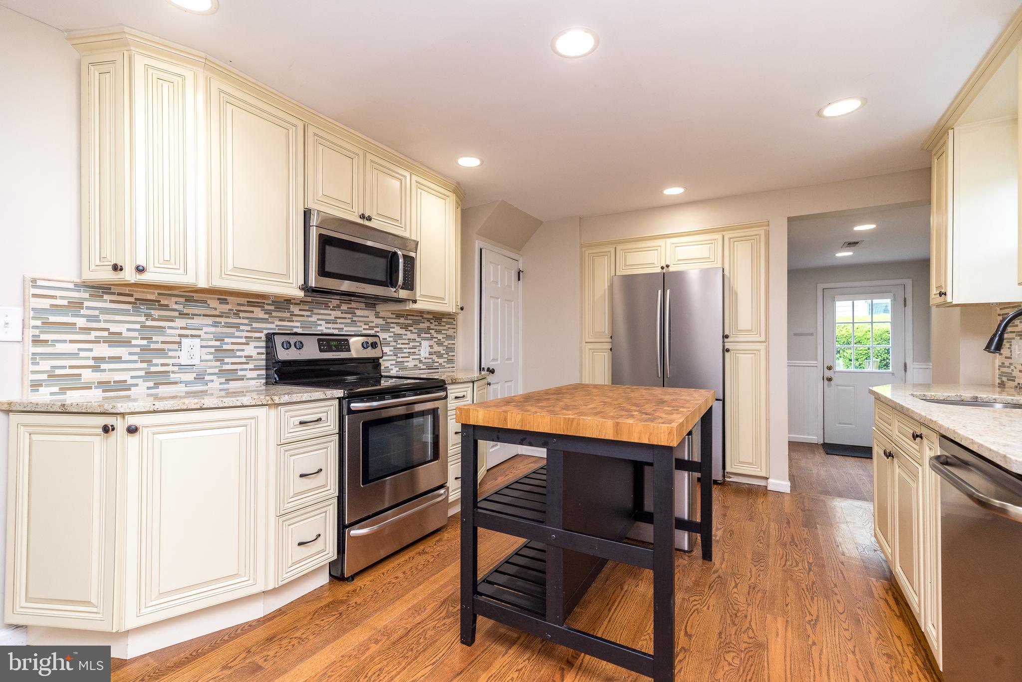 1425 Leedom Road Havertown, PA 19083 - Photo 1 of 46 a kitchen with stainless steel appliances kitchen island granite countertop a stove a sink and a microwave
