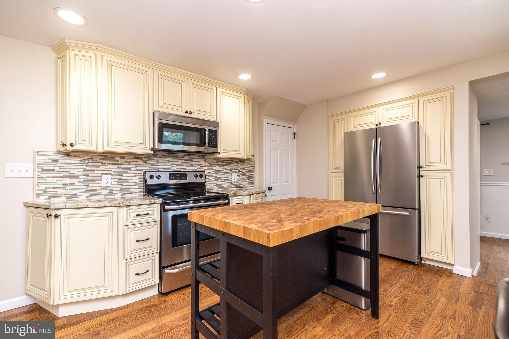 1425 Leedom Road Havertown, PA 19083 - Photo 13 of 46 a kitchen with stainless steel appliances granite countertop a stove refrigerator sink and microwave