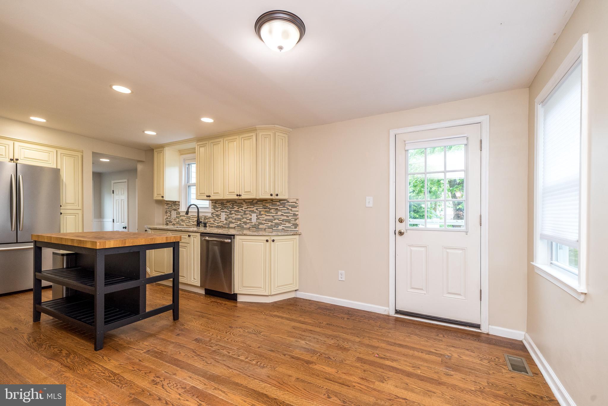 1425 Leedom Road Havertown, PA 19083 - Photo 14 of 46 a kitchen with stainless steel appliances white cabinets and wooden floor