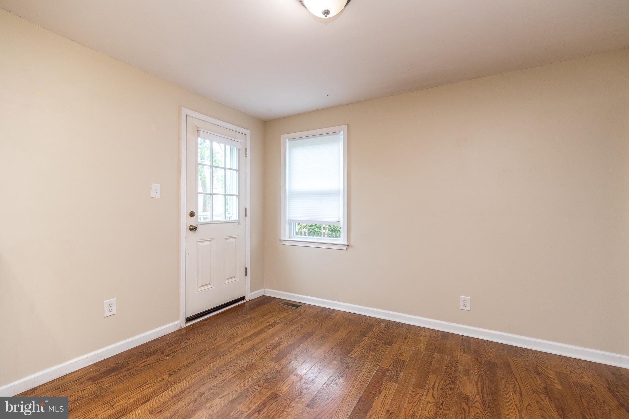1425 Leedom Road Havertown, PA 19083 - Photo 16 of 46 an empty room with wooden floor and windows