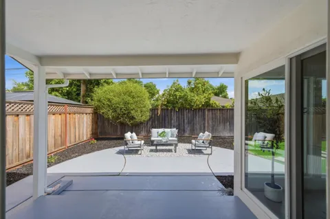 a living room with furniture and a garden