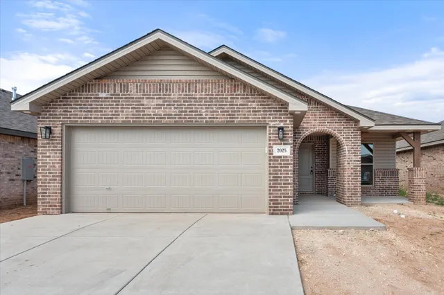 a front view of a house with garage