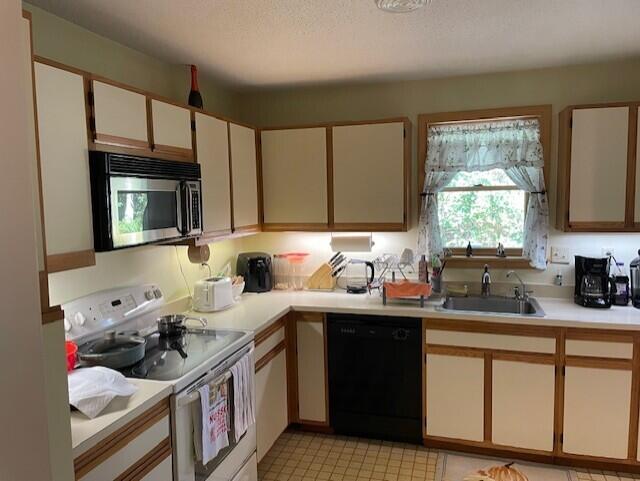 720 Pitchers Way, Unit 40F Hyannis, MA 02601 - Photo 2 of 2 a kitchen with a sink stove top oven and cabinets