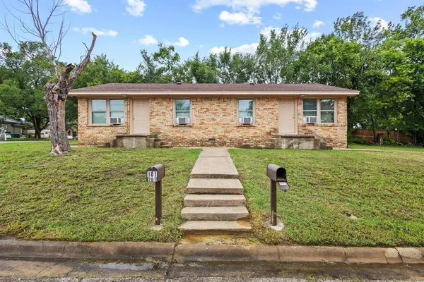 a front view of house with yard and green space