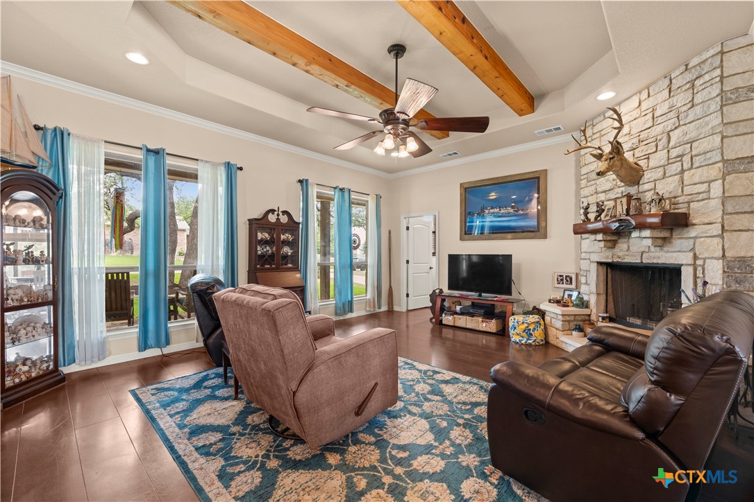 2649 Bowles Ranch Road Belton, TX 76513 - Photo 11 of 36 a living room with furniture a fireplace and a chandelier