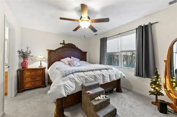 a bedroom with a bed and a dresser