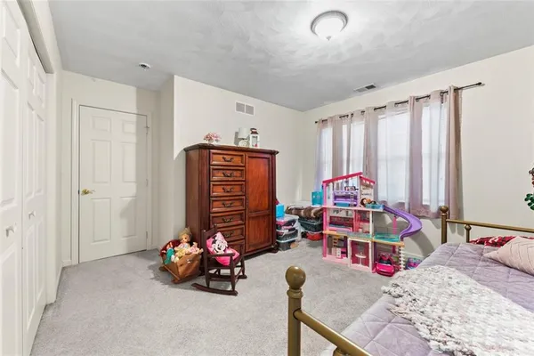 a living room with furniture and a gym machine