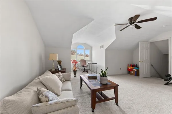 a view of a workspace with furniture and a potted plant