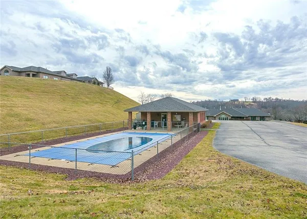 a view of a house with swimming pool and sitting area