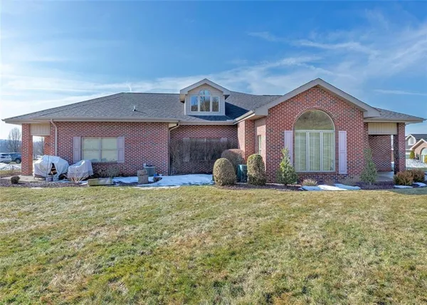 a front view of a house with a garden and porch