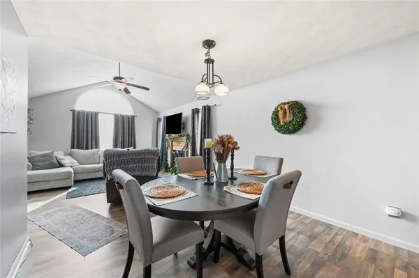 a view of a dining room with furniture and chandelier