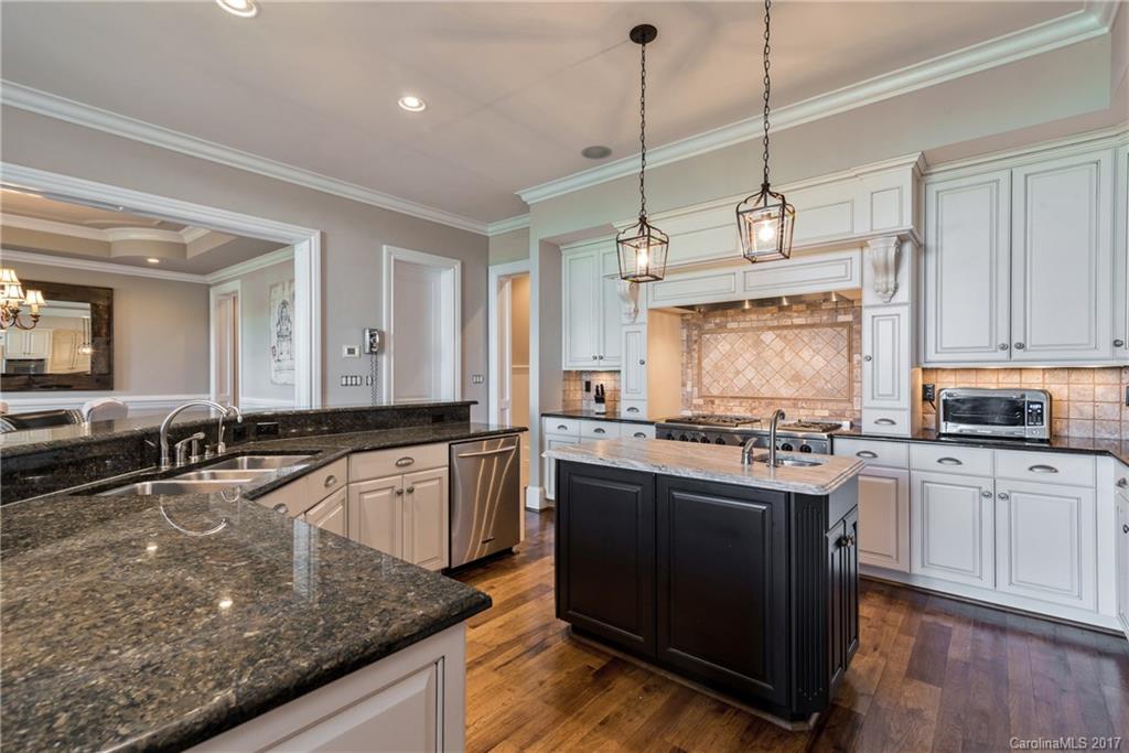 204 Eagle Bend Drive Waxhaw, NC 28173 - Photo 8 of 24 a large kitchen with kitchen island granite countertop a stove a sink a oven a dining table and chairs