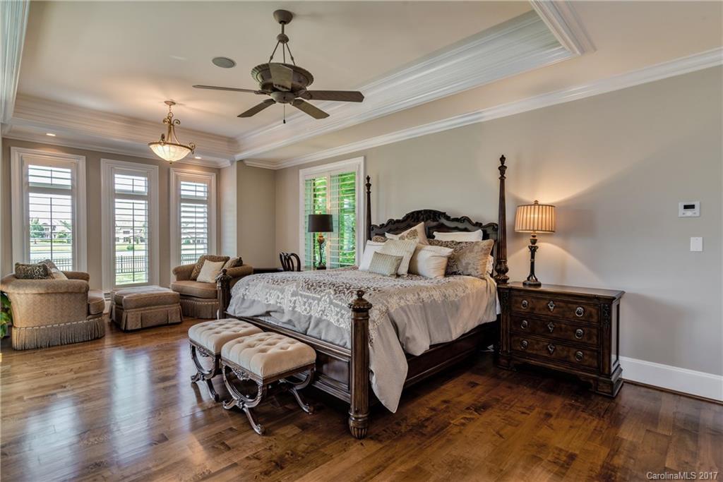 204 Eagle Bend Drive Waxhaw, NC 28173 - Photo 10 of 24 a bedroom with a bed couch chandelier and a window
