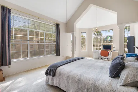 a bedroom with bed and window