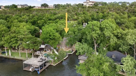 an aerial view of a house with a yard patio and lake view