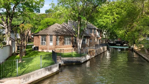 a view of a house with swimming pool next to a yard