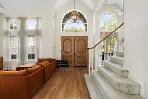 a living room with furniture and a clock
