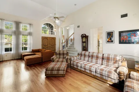 a spacious bedroom with bed couch and window