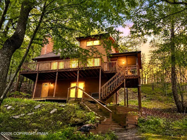 a kitchen with stainless steel appliances granite countertop a refrigerator a sink a stove a washer dryer and cabinets