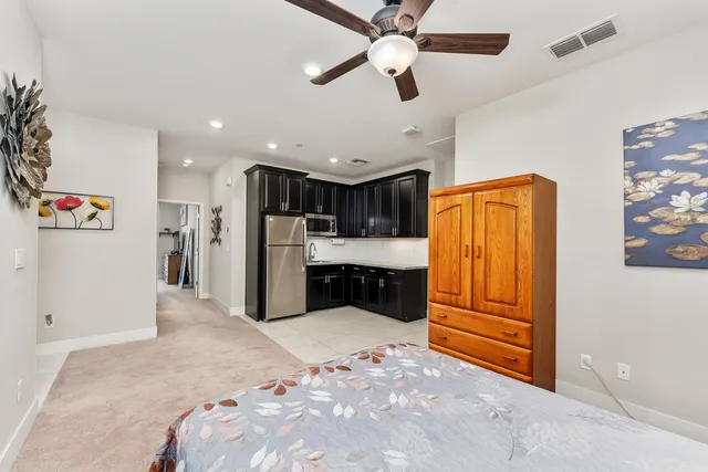 a view of kitchen with refrigerator and ceiling fan