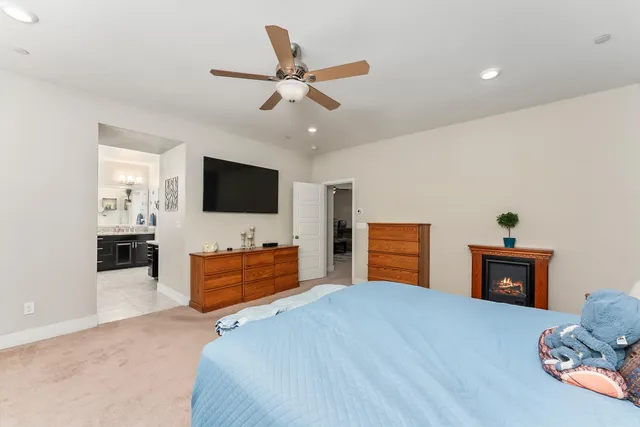 a bedroom with furniture and a flat screen tv