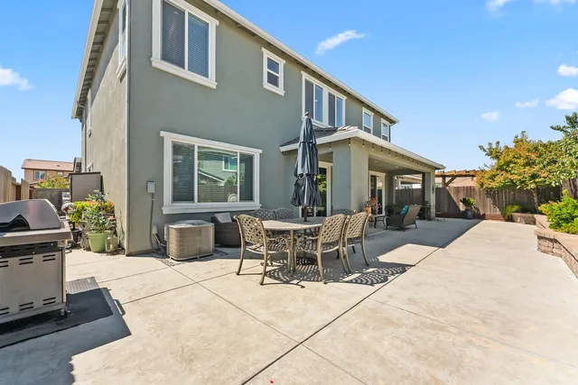 a building outdoor space with patio furniture and garden