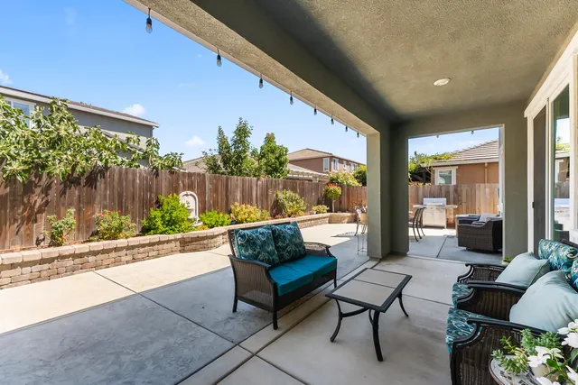 a balcony with furniture and a garden