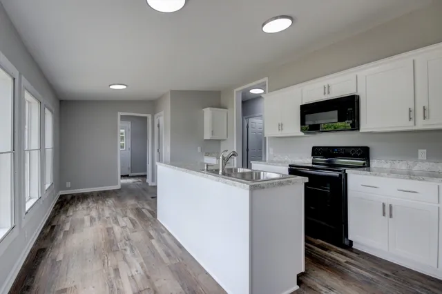 a kitchen with a sink and a stove top oven