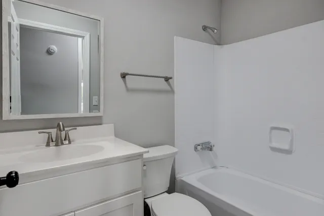 a house that has a tree in front of it