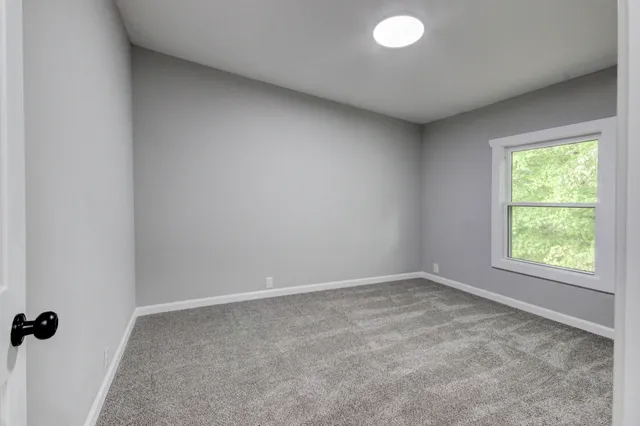 a view of a house with a yard and trees