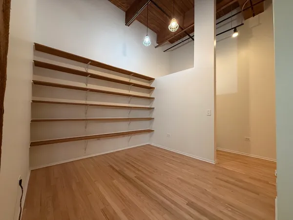 a view of a room with wooden floor and a cabinet