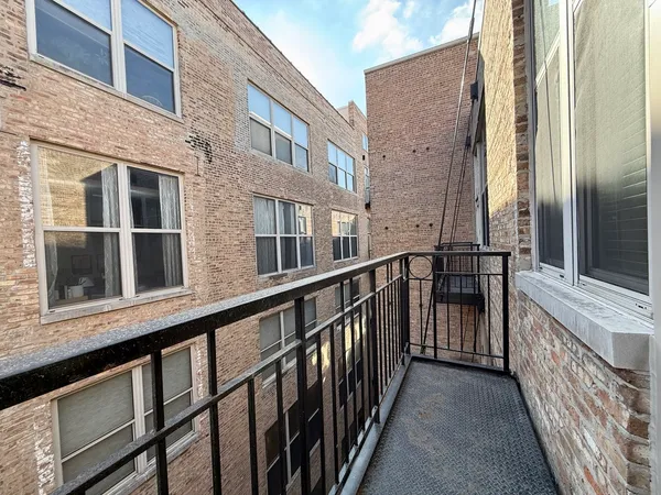 a view of a brick building from a balcony