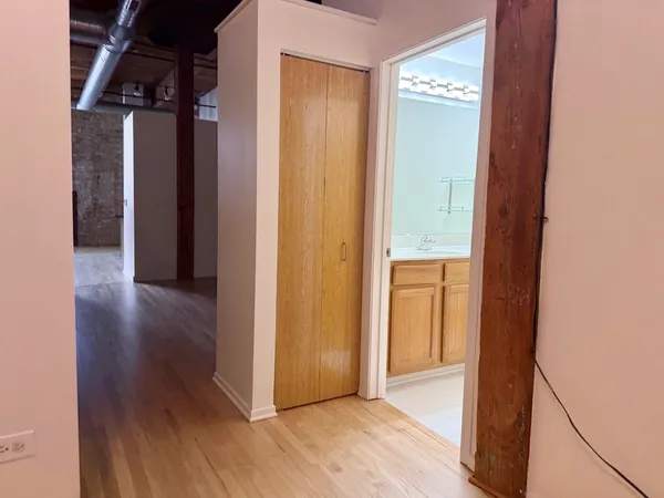 a view of a hallway with wooden floor