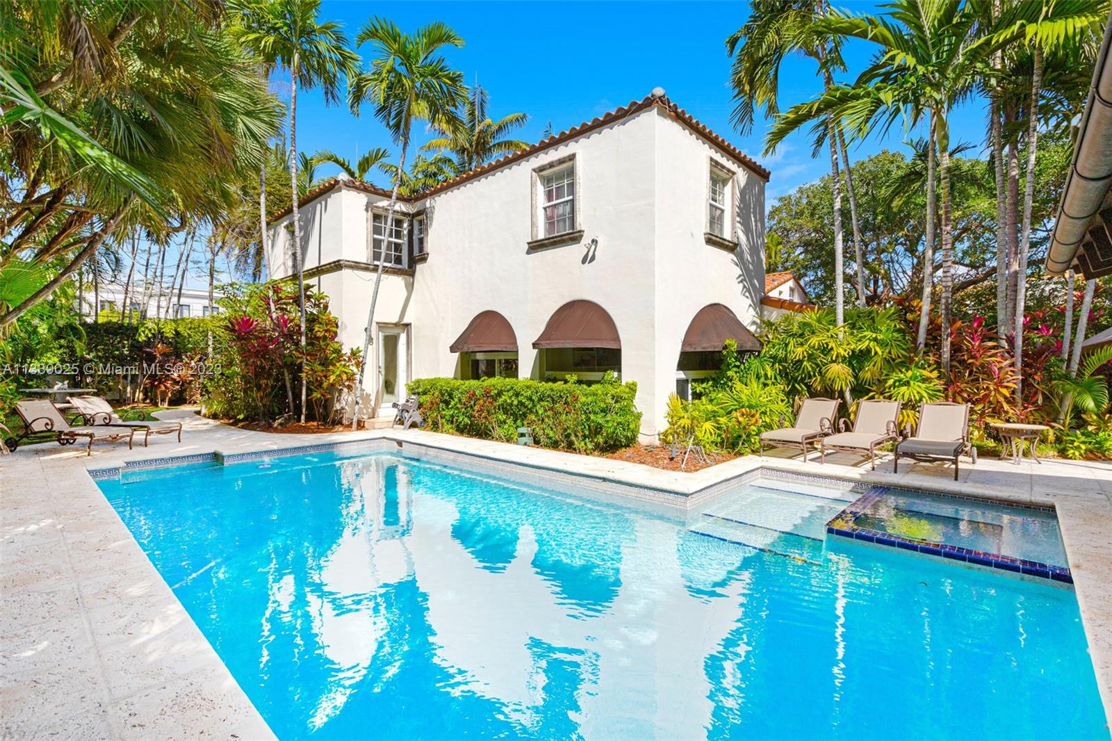 a view of a white house with a swimming pool