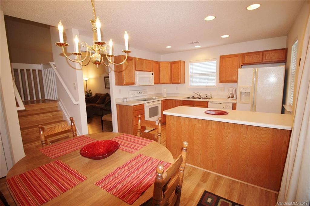 8254 Rudolph Road Charlotte, NC 28216 - Photo 8 of 24 a kitchen with a sink and wooden cabinets