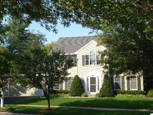 1700 Forest Ridge Road St. Charles, IL 60174 - Photo 1 of 1 a view of a white house next to a yard with big trees