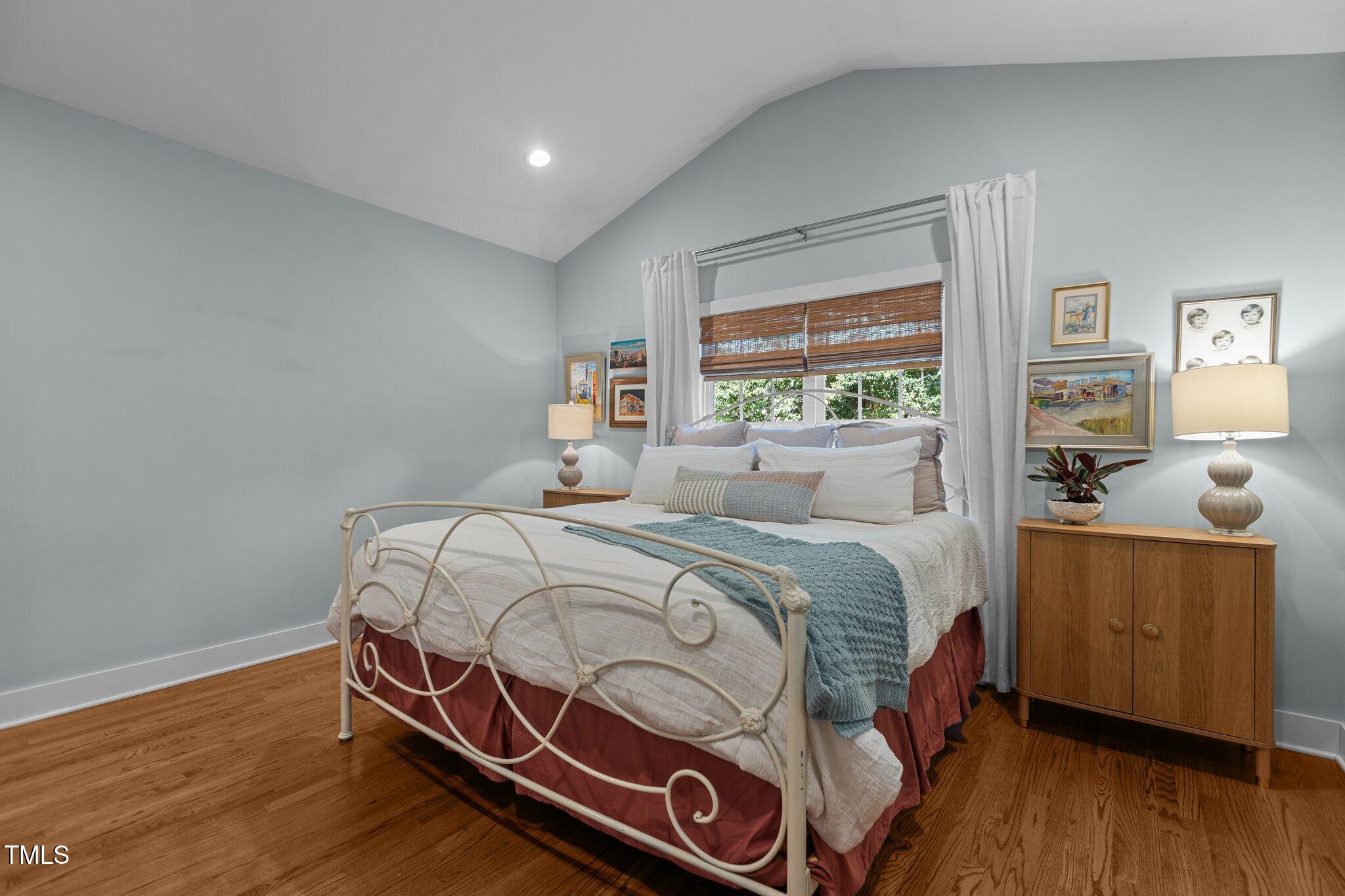 1811 Ridley Street Raleigh, NC 27608 - Photo 15 of 48 a bedroom with a bed and wooden floor