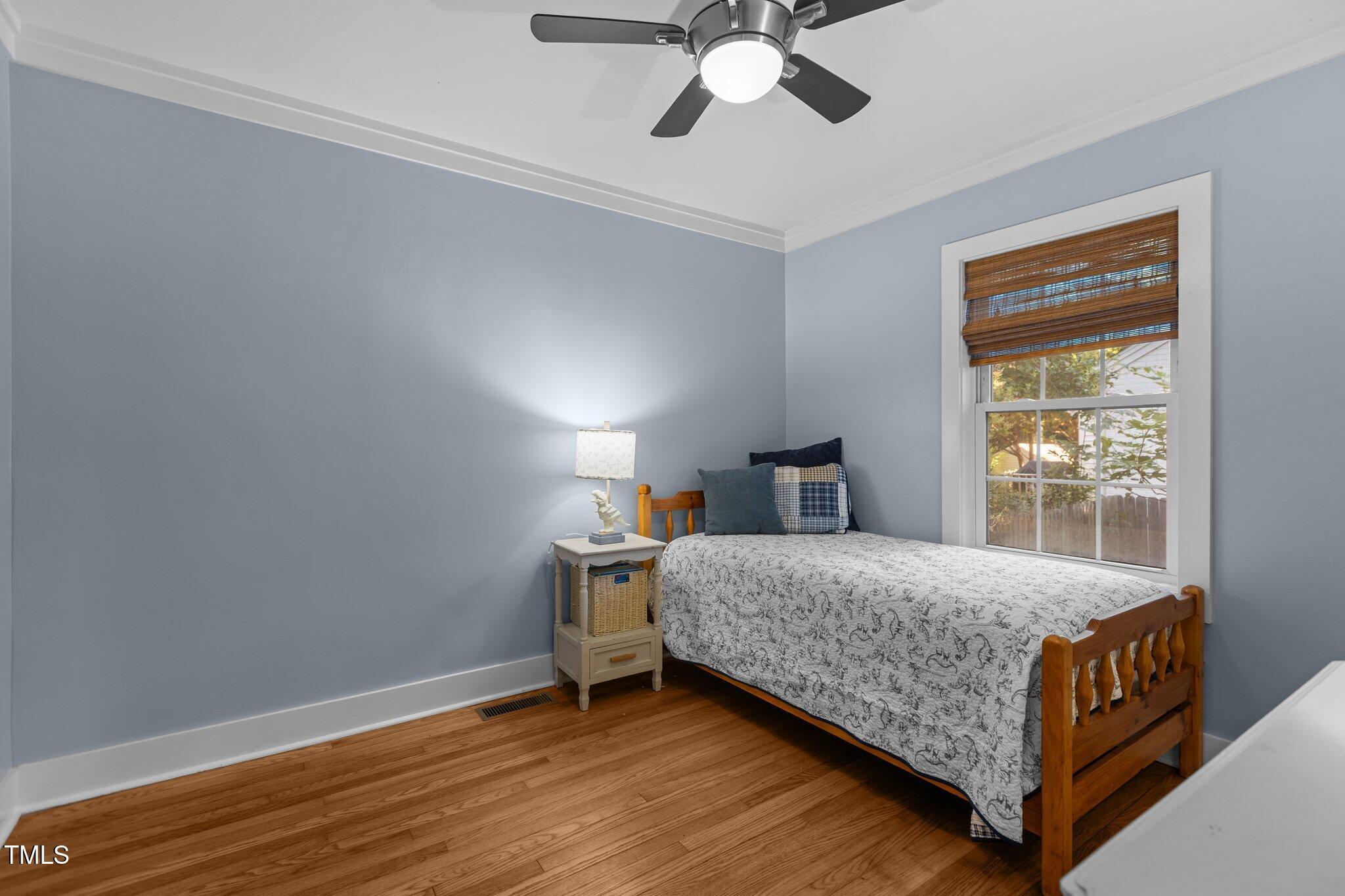 1811 Ridley Street Raleigh, NC 27608 - Photo 21 of 48 a bedroom with a bed and window