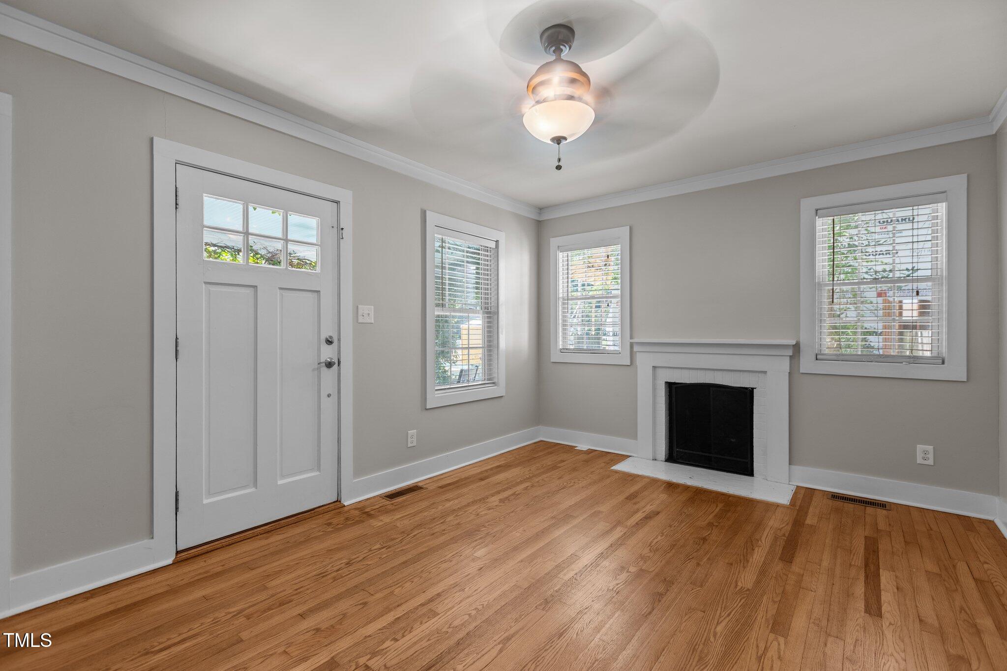 1811 Ridley Street Raleigh, NC 27608 - Photo 30 of 48 an empty room with wooden floor fan and windows