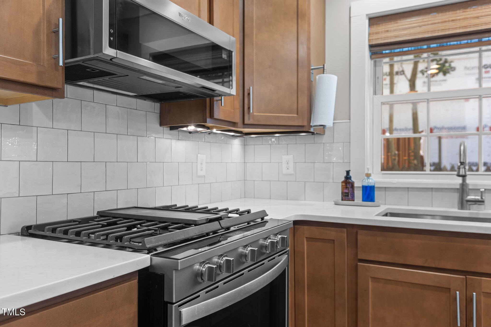 1811 Ridley Street Raleigh, NC 27608 - Photo 10 of 48 a kitchen with granite countertop a stove and a sink
