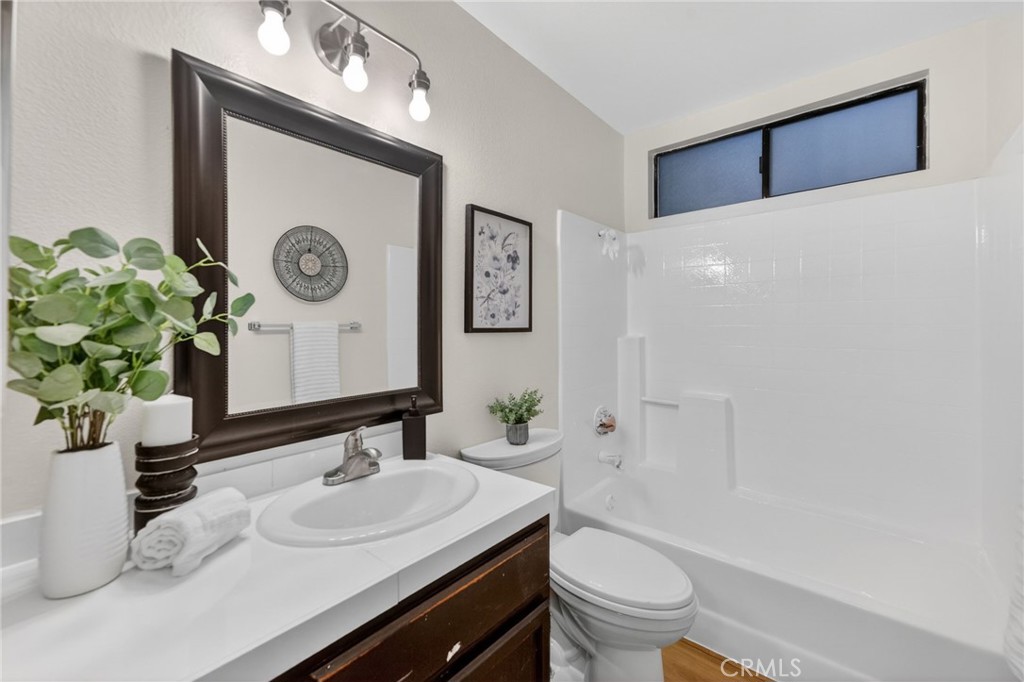 32042 Merlot Court Temecula, CA 92591 - Photo 31 of 46 a bathroom with a sink a toilet and a mirror