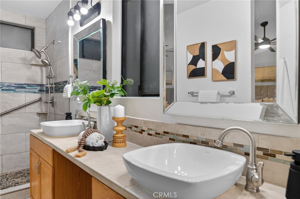 32042 Merlot Court Temecula, CA 92591 - Photo 36 of 46 a bathroom with a granite countertop sink and a mirror