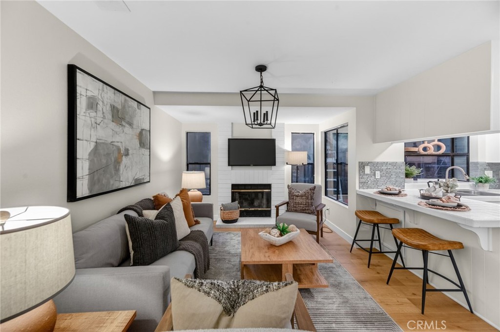 32042 Merlot Court Temecula, CA 92591 - Photo 10 of 46 a living room with furniture a fireplace and a flat screen tv