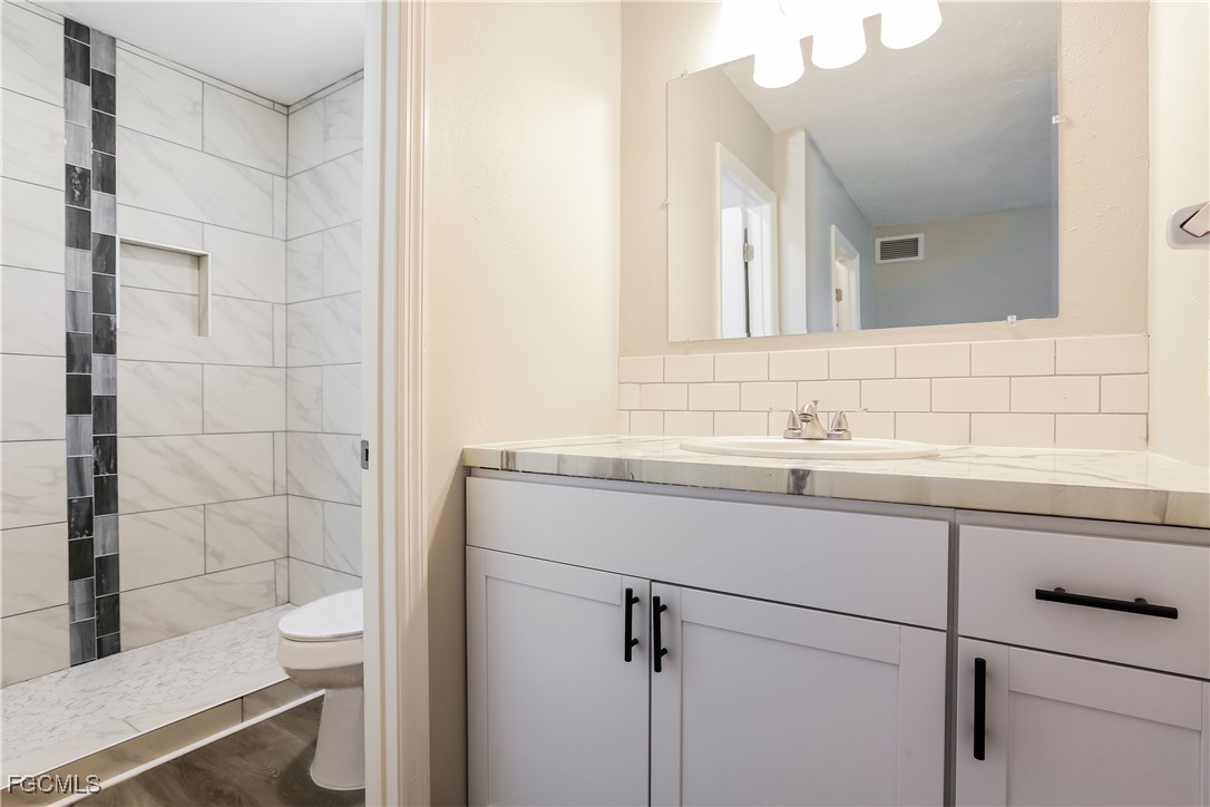 4007 Allure Lane North Port, FL 34287 - Photo 12 of 16 a bathroom with a sink a toilet and shower