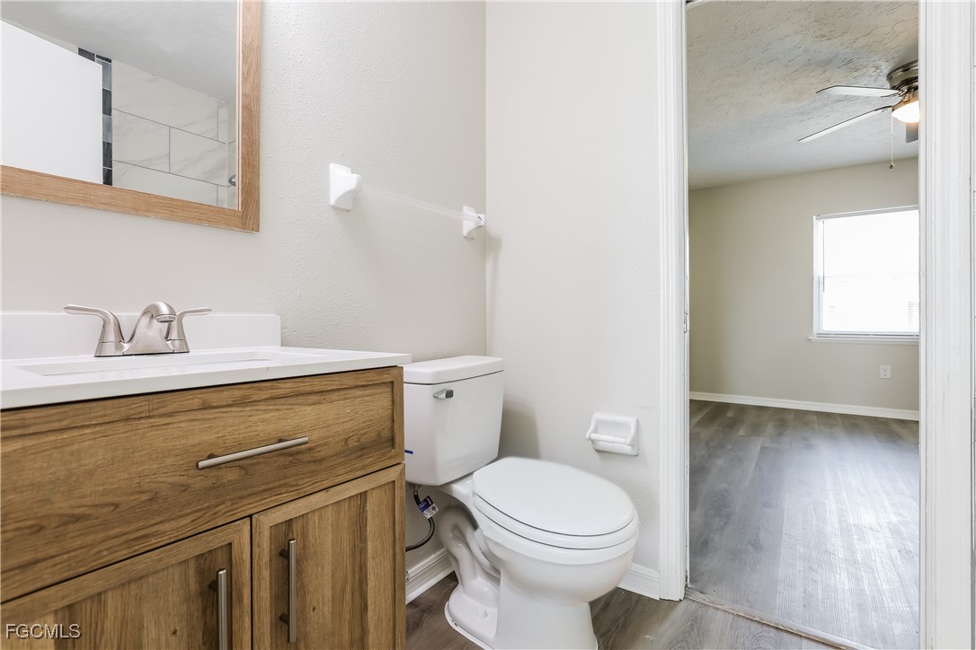 4007 Allure Lane North Port, FL 34287 - Photo 13 of 16 a bathroom with a toilet a sink and mirror