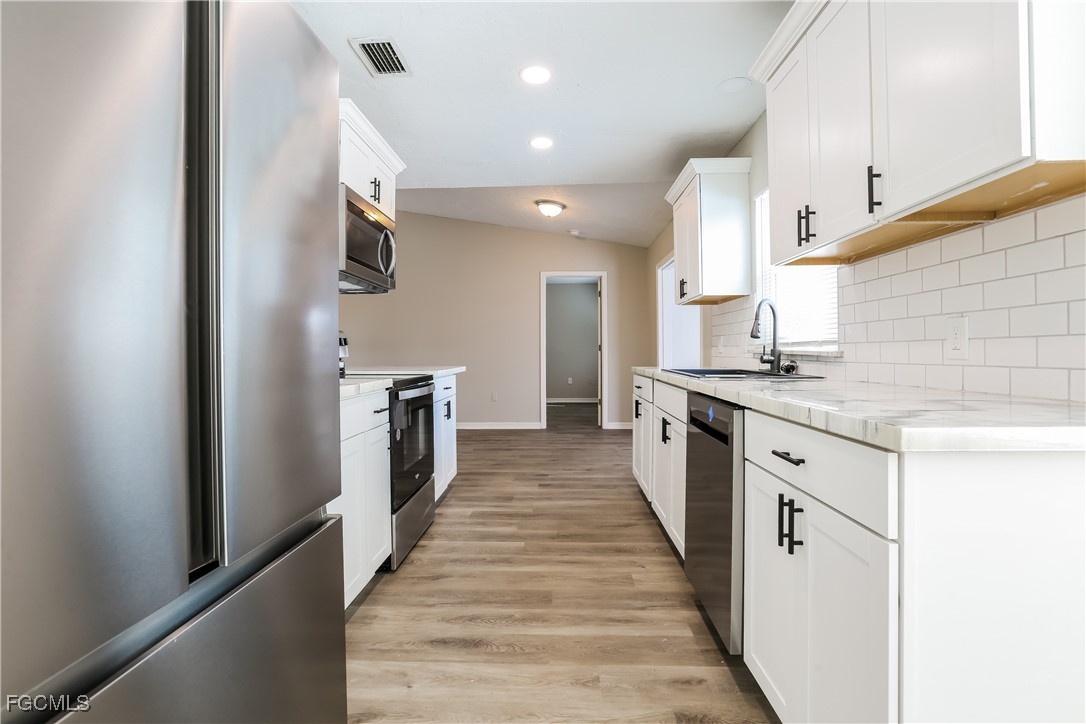 4007 Allure Lane North Port, FL 34287 - Photo 3 of 16 a large kitchen with stainless steel appliances