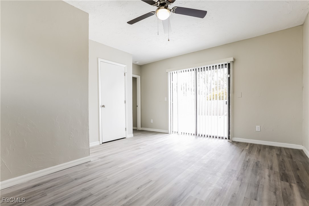 4007 Allure Lane North Port, FL 34287 - Photo 5 of 16 wooden floor in an empty room with a window