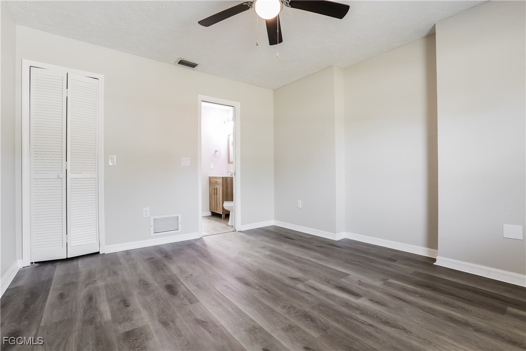 4007 Allure Lane North Port, FL 34287 - Photo 7 of 16 an empty room with wooden floor cabinet and windows