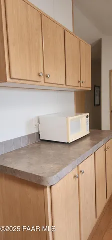 a bed sitting in a bedroom next to a small window